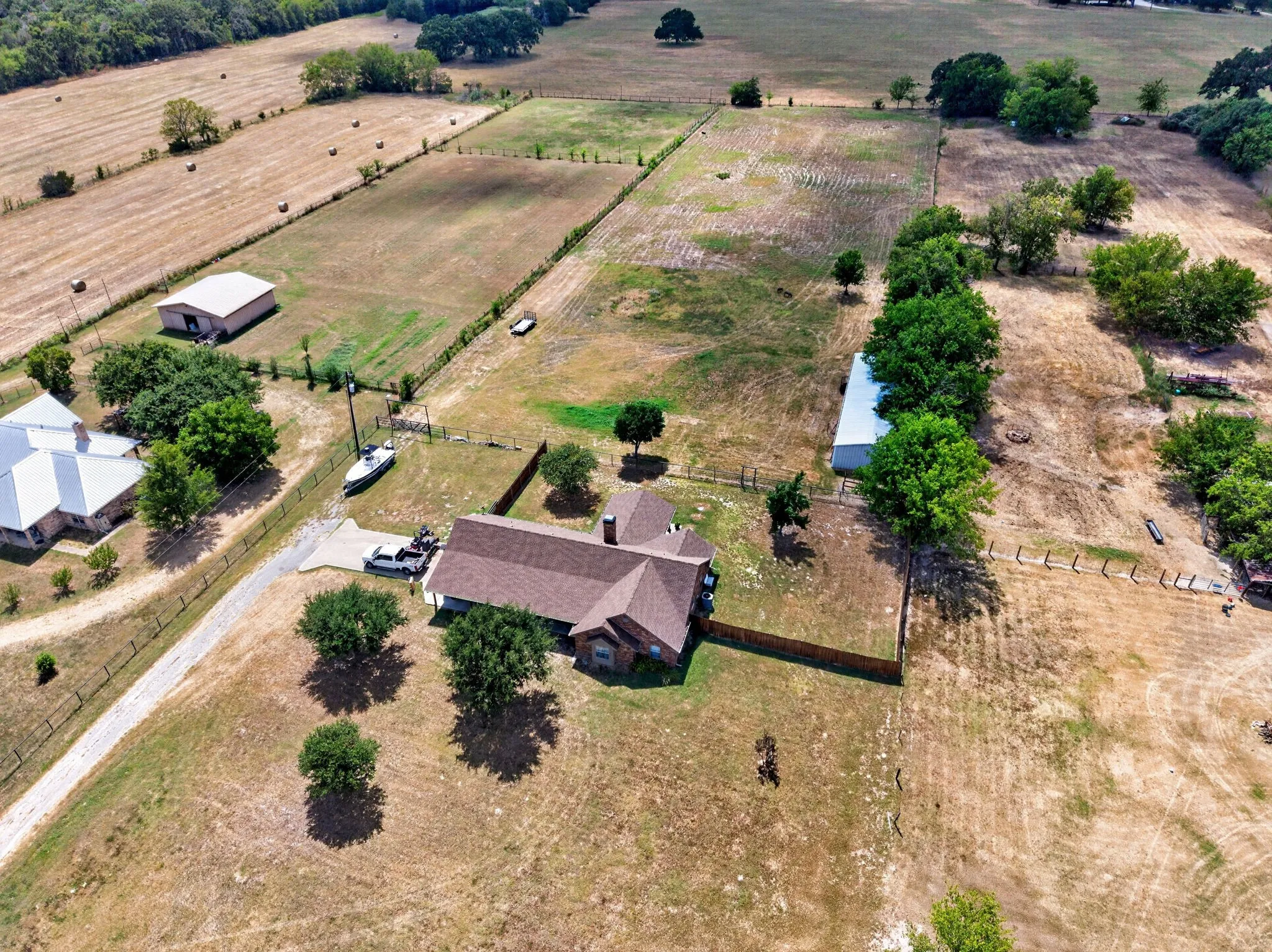 Expansive parcel with multiple structures and fenced areas