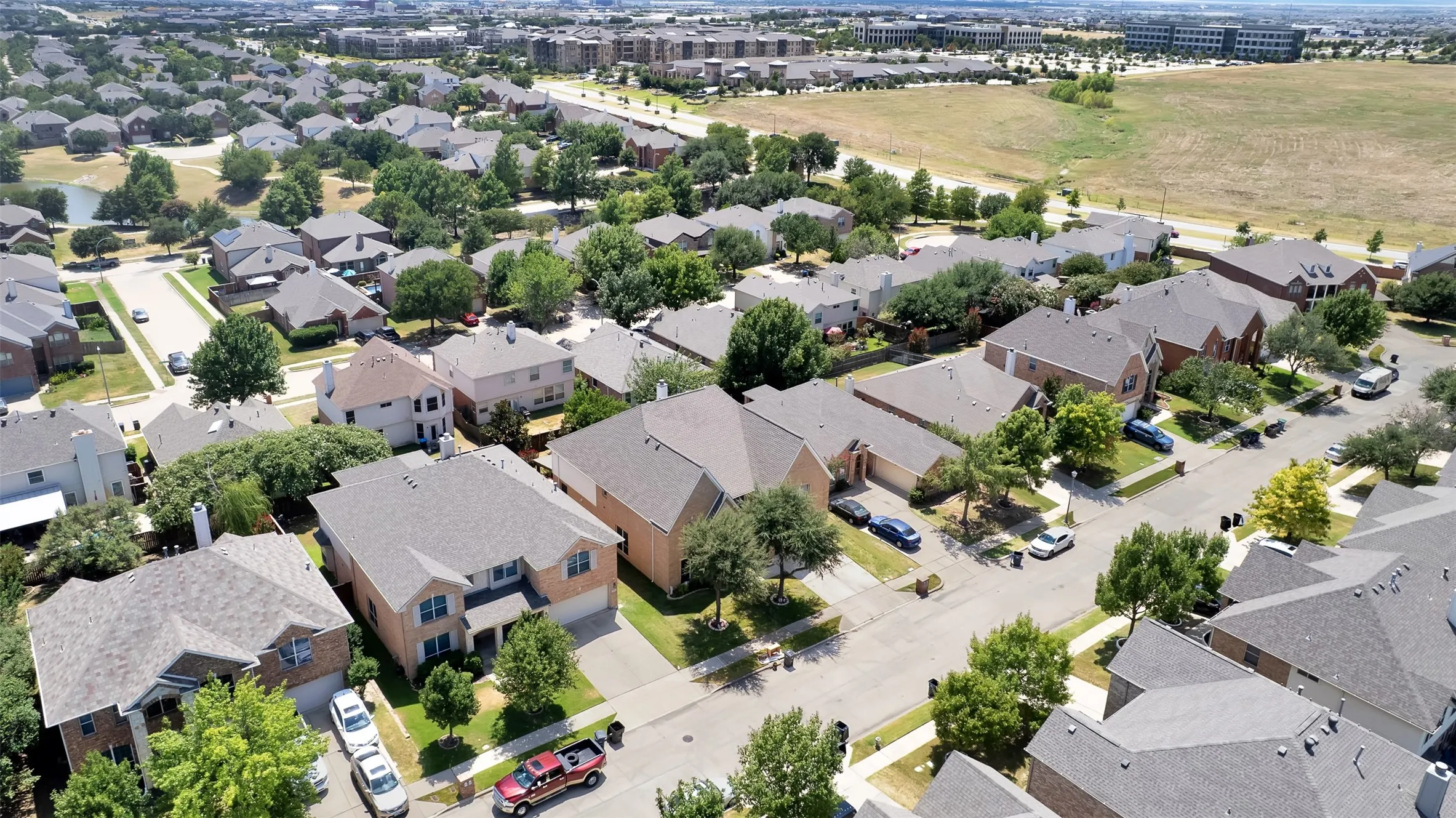 Residential neighborhood with a variety of single-family homes, mature trees, and paved streets