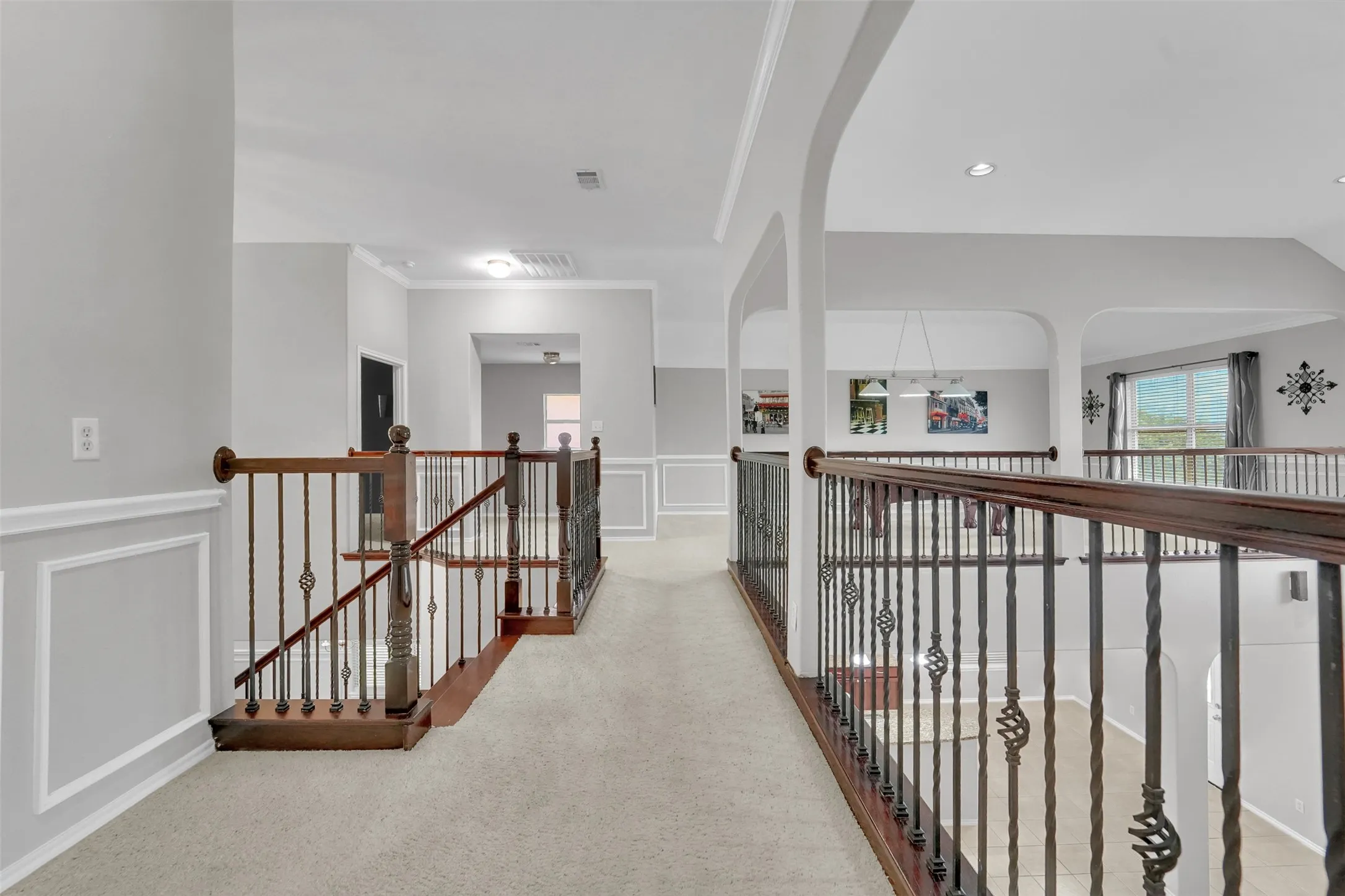 Arched doorways, wall paneling, and crown molding