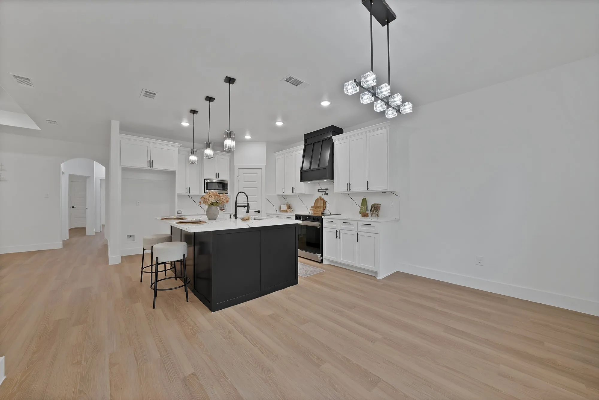 Open-concept living area with light wood-finish flooring