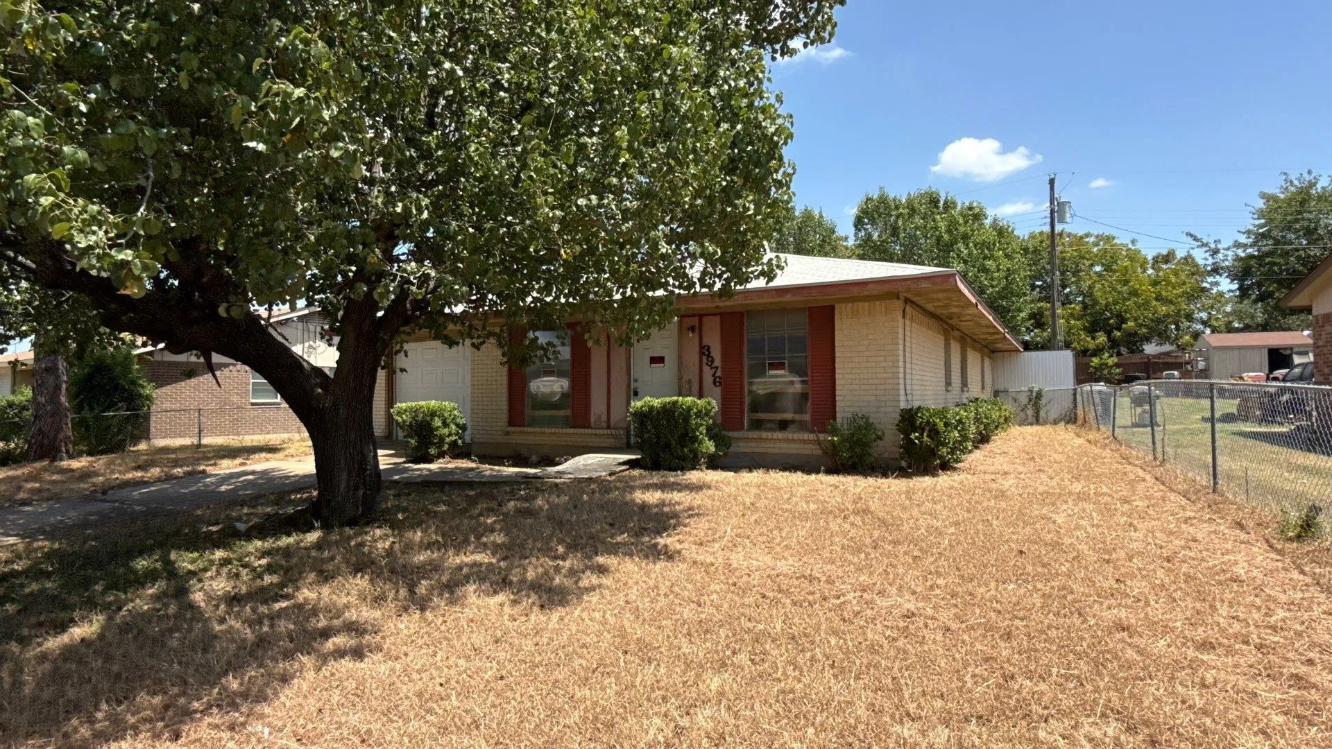 Single-story residence featuring a brick exterior and a fenced yard
