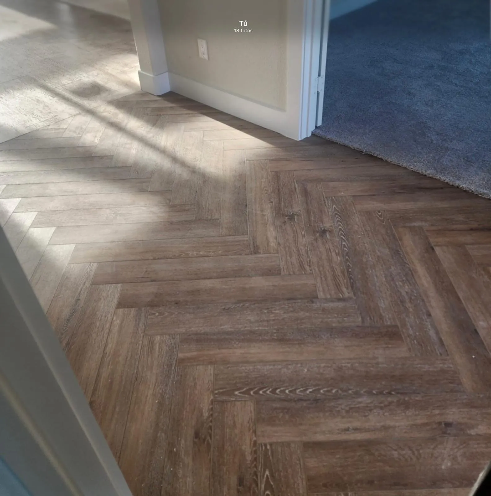 Herringbone wood-finish flooring with a subtle grain pattern