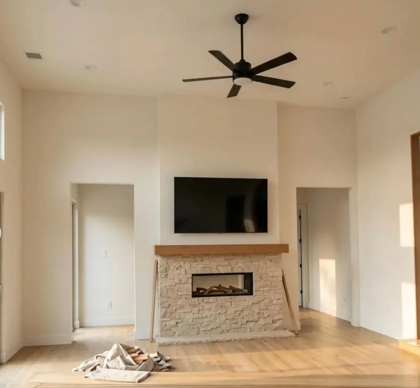 High ceilings with recessed lighting, a ceiling fan, and light wood-finish flooring