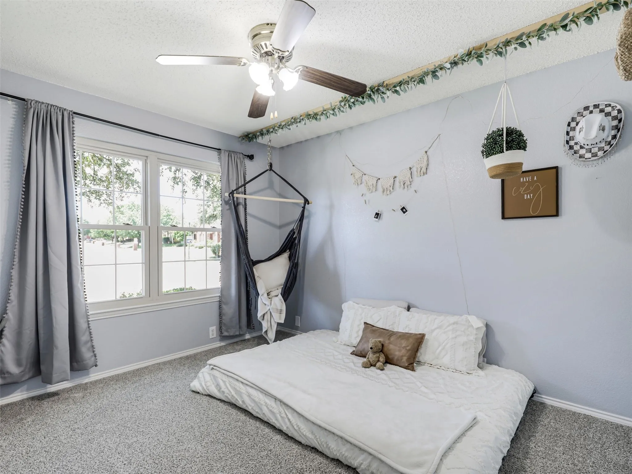 Double-hung windows, carpeted flooring, and a ceiling fan with integrated lighting