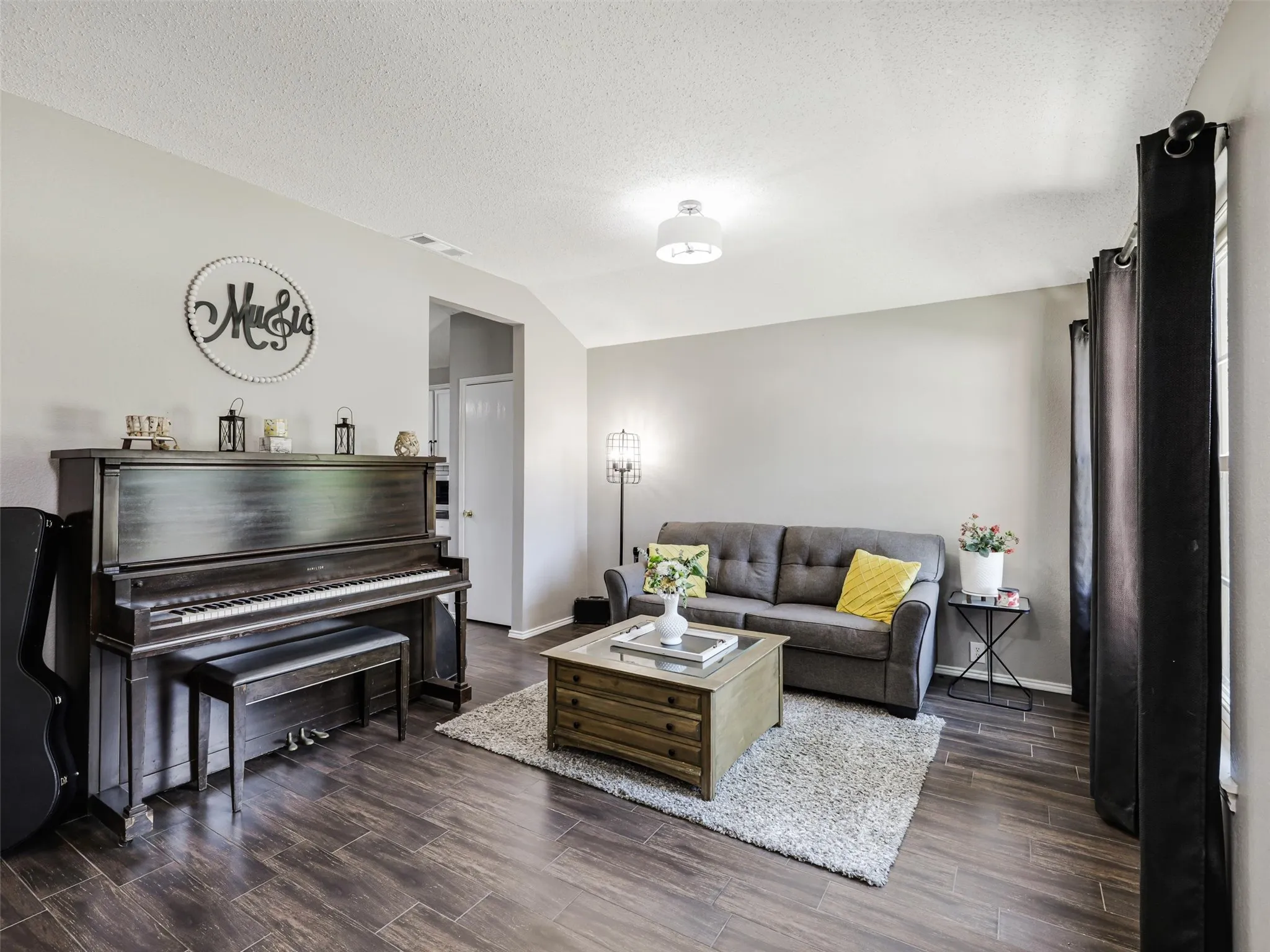 Vaulted ceiling, wood-finish flooring, recessed lighting, and neutral wall tones