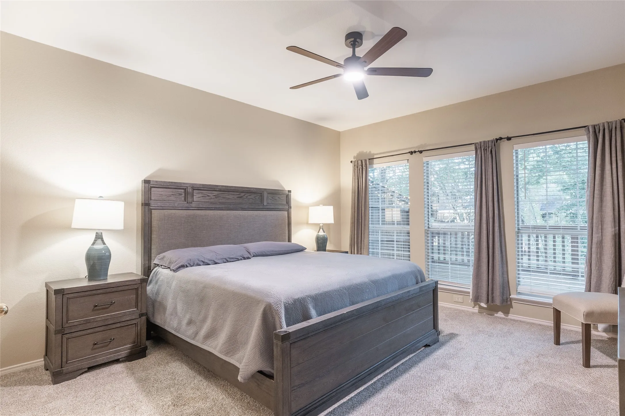 Recessed lighting with a ceiling fan, multiple windows with blinds, and carpeted flooring