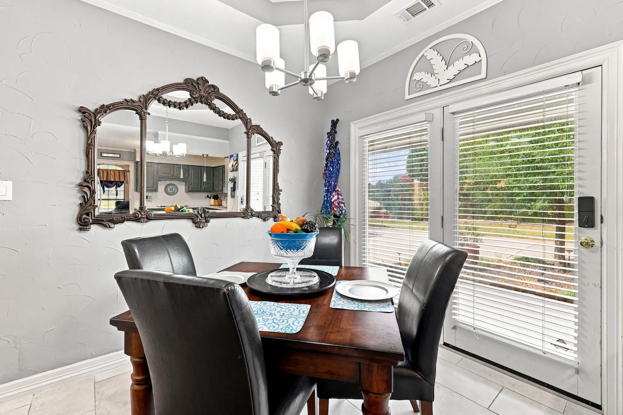Recessed ceiling with a contemporary chandelier, light gray wall finish, and tiled flooring