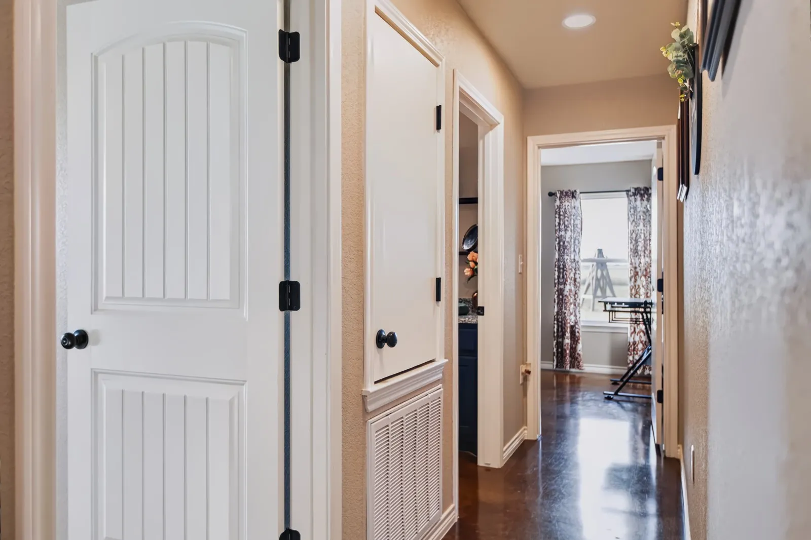 Hallway featuring recessed lighting, dark wood-finish flooring, and white paneled doors with dark hardware