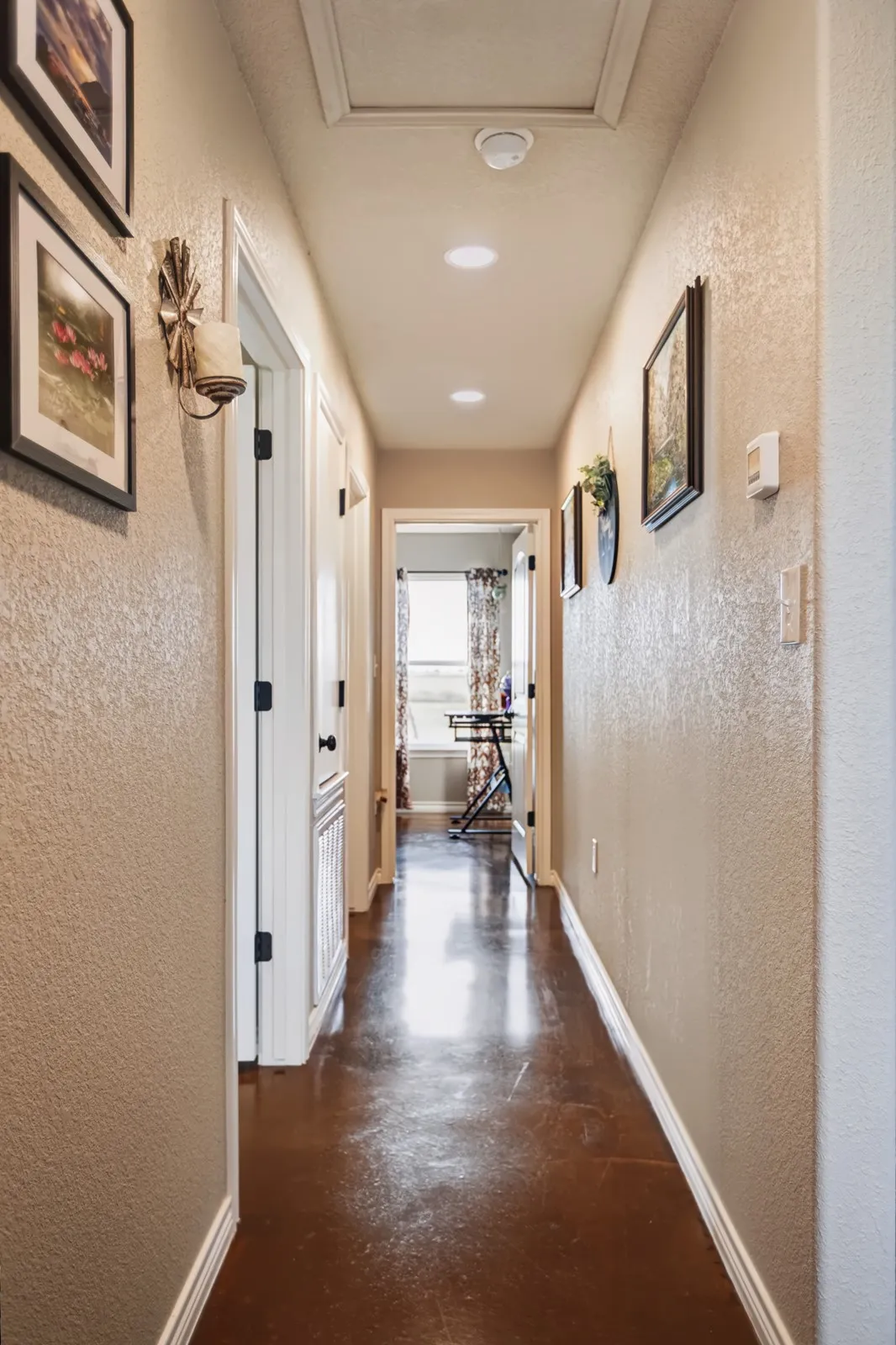 Polished concrete flooring, recessed lighting, and crisp white trim