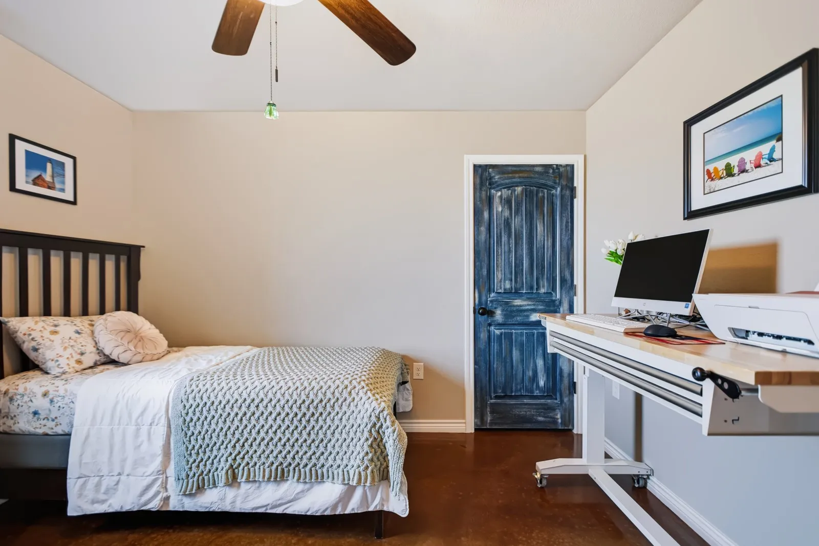 Guest Room 1
Warm tone walls, brown wood-finish flooring, and a ceiling fan with light fixture