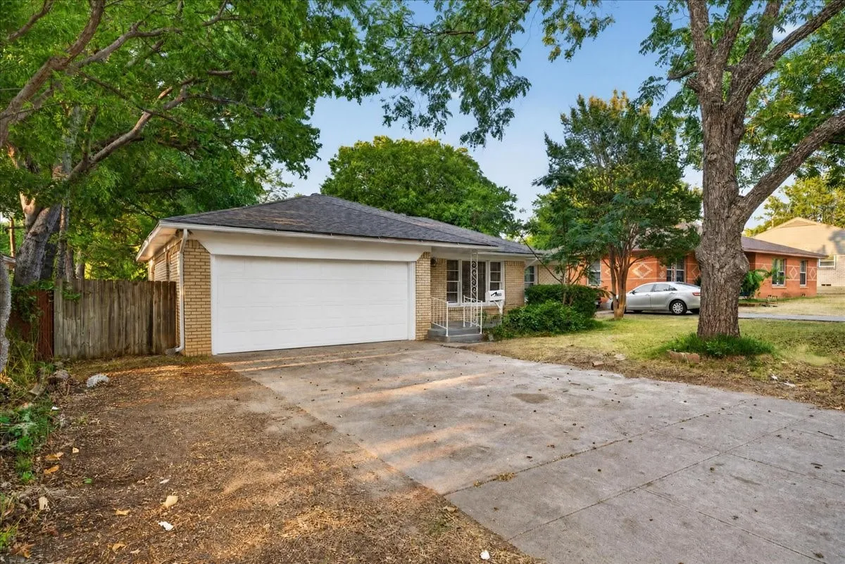 Brick exterior with a single-car garage and concrete driveway
