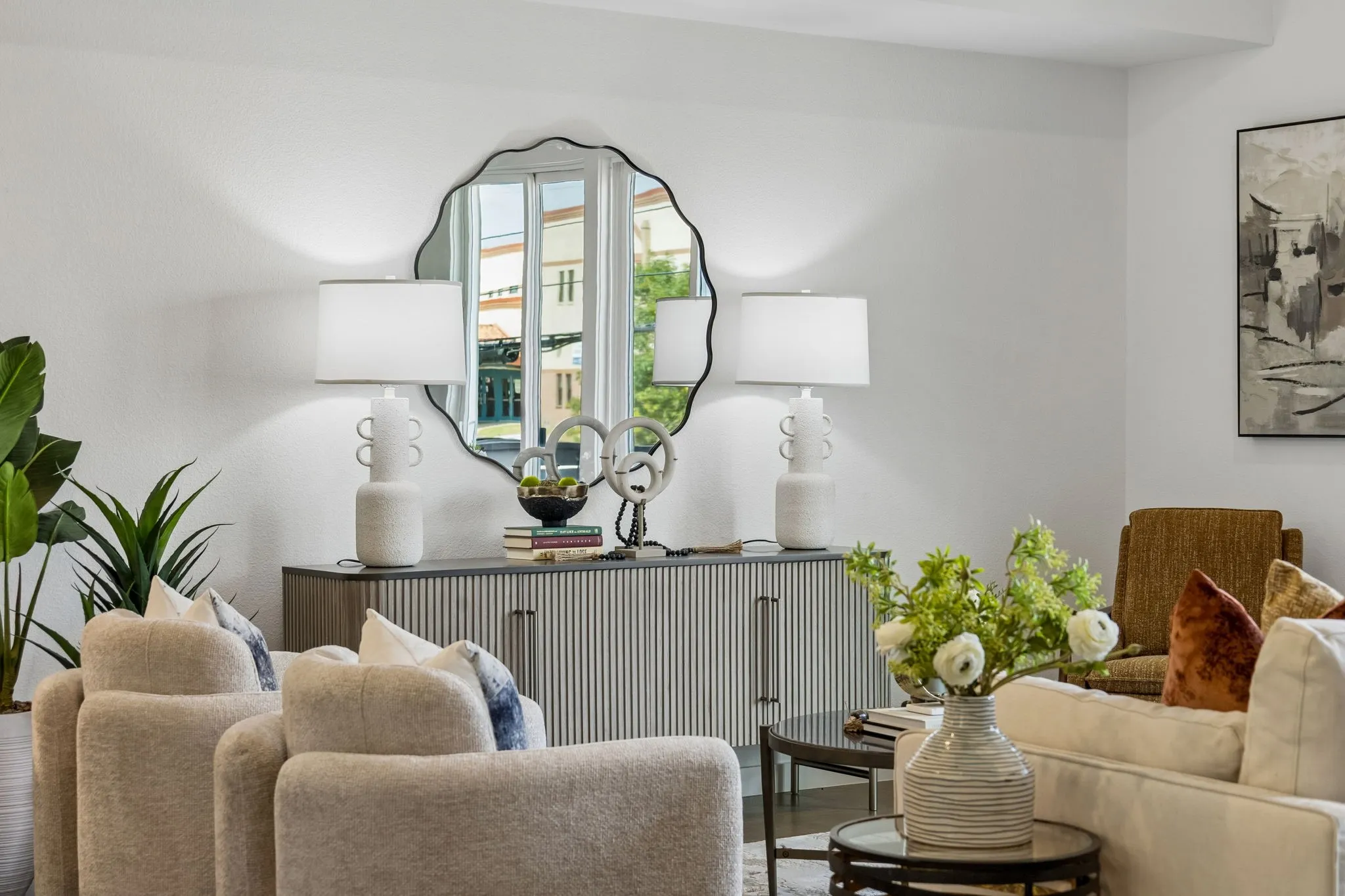 Integrated console table with fluted detailing, decorative mirror, and neutral wall paint