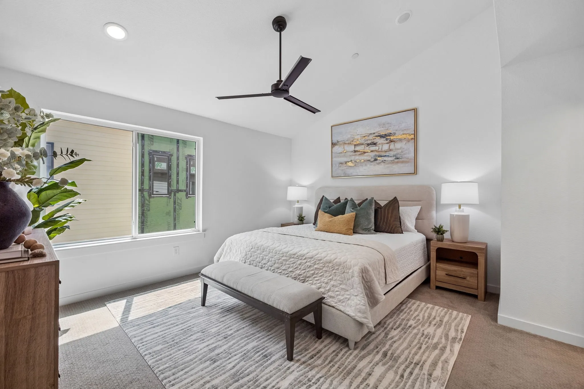 Vaulted ceiling, recessed lighting, ceiling fan, large window, and wood-finish nightstands