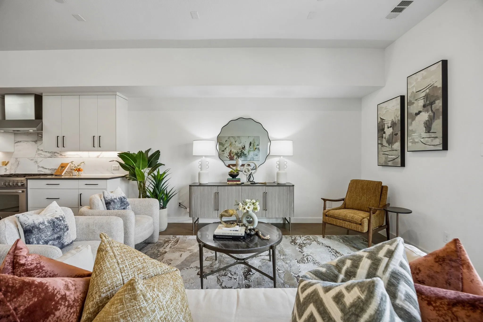 Open-concept living space with light wood-finish flooring, white walls, and recessed lighting