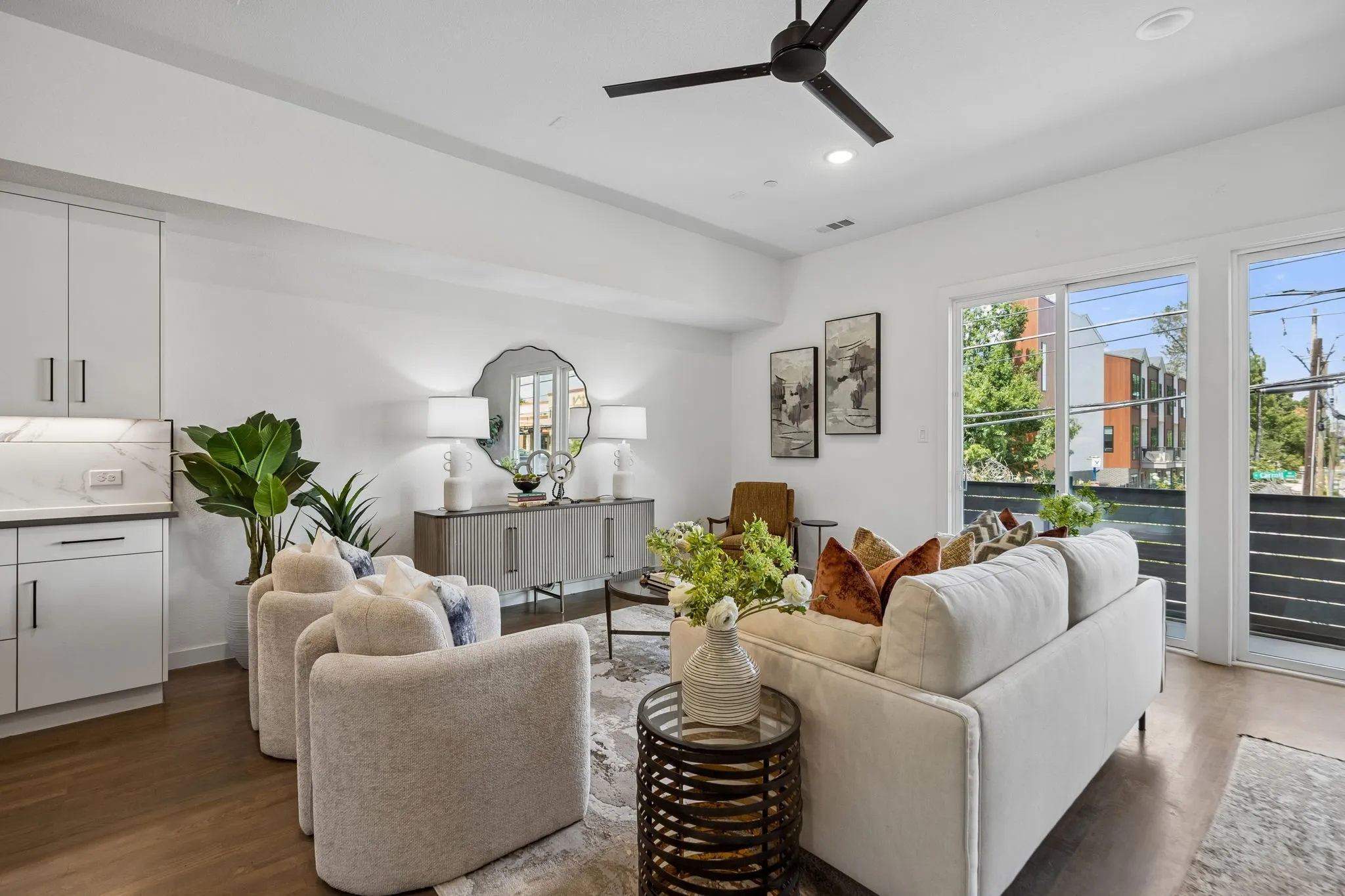 Spacious living area featuring wood-finish flooring, recessed lighting, and a modern ceiling fan
