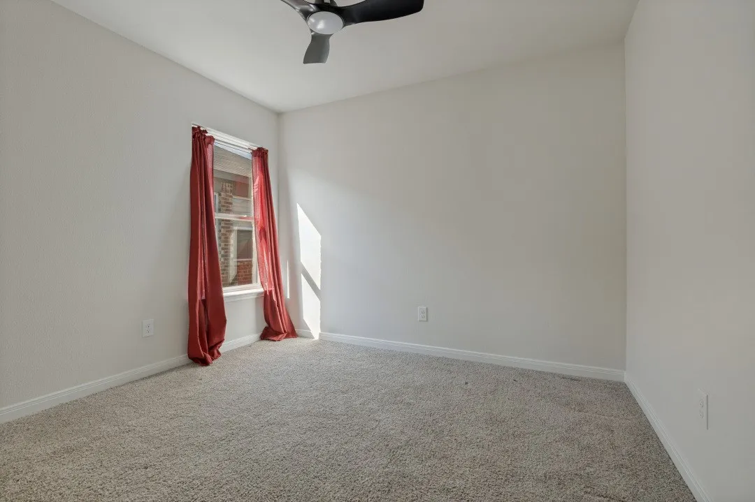 Neutral-toned walls complement the textured carpeting