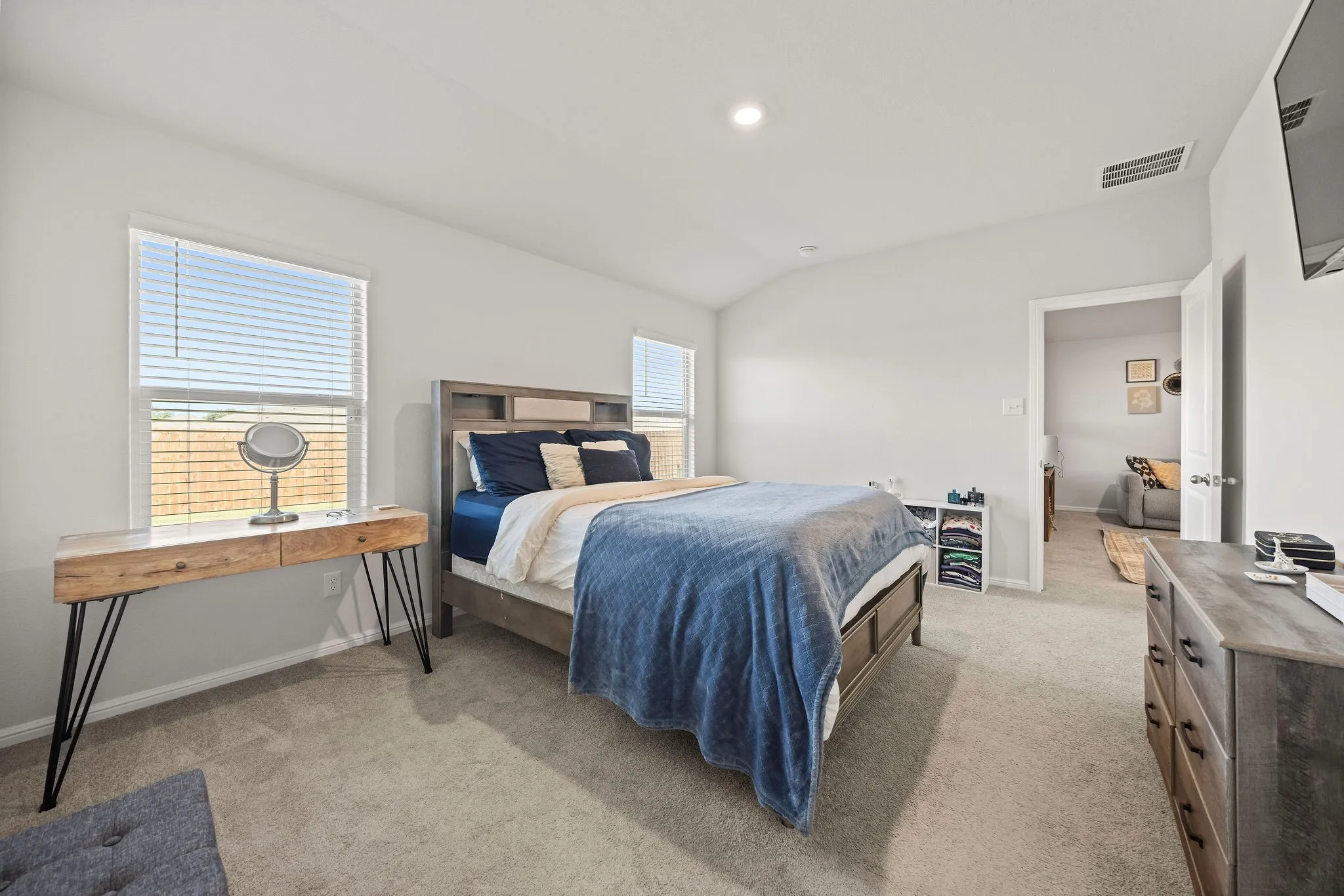 Bedroom with light colored carpet and recessed lighting
