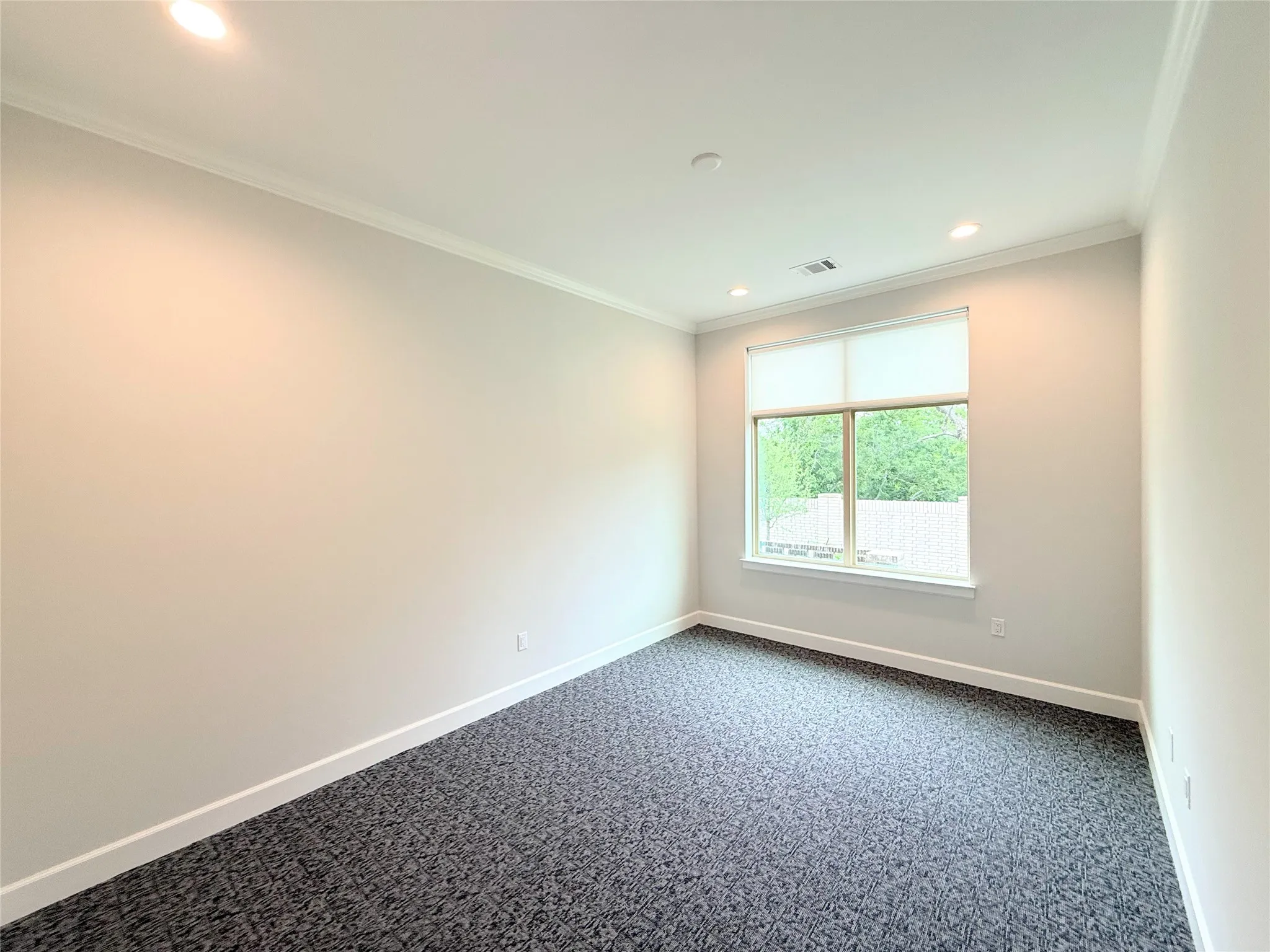 Recessed lighting, crown molding, white trim, neutral-toned walls, and patterned carpet flooring