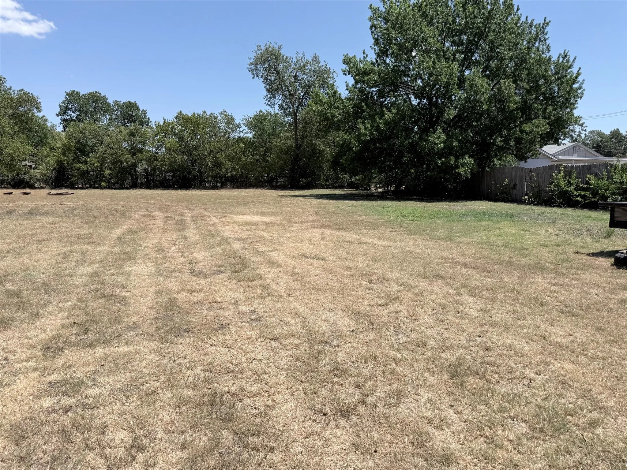 Expansive lot with mature perimeter trees, offering ample green space