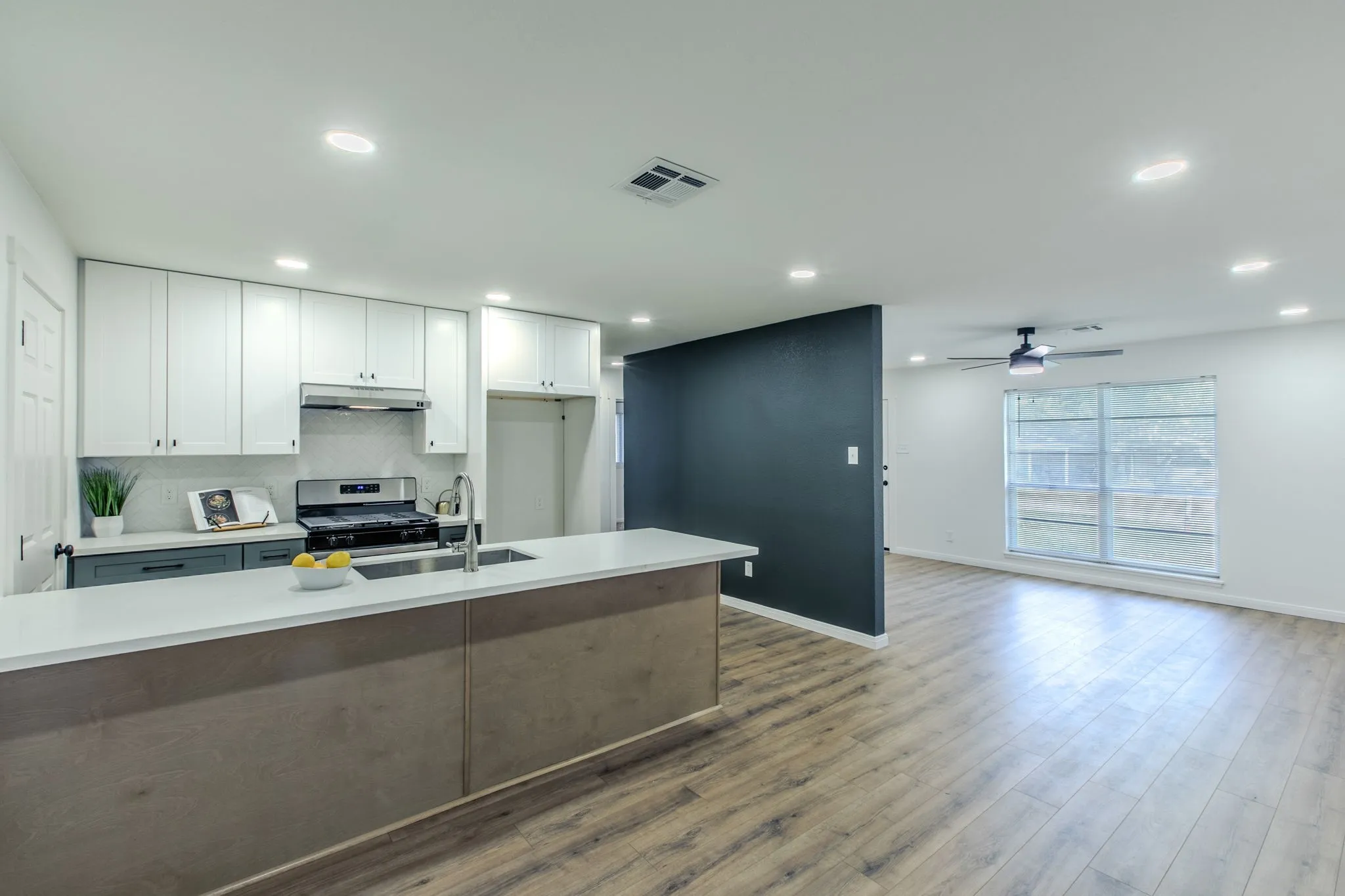 Open-concept living space with wood-finish flooring