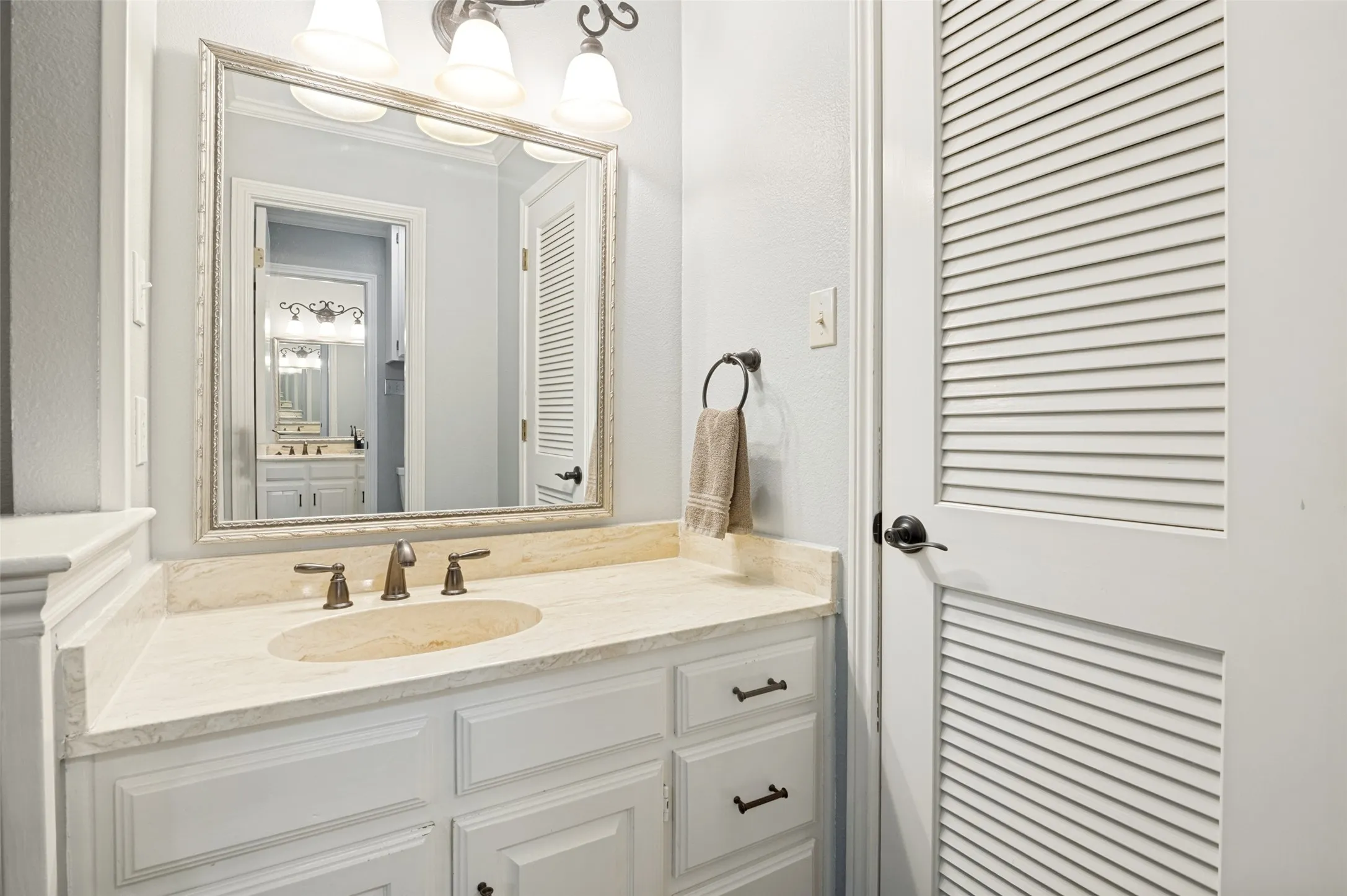 Spacious primary bathroom with separate vanities and sinks.