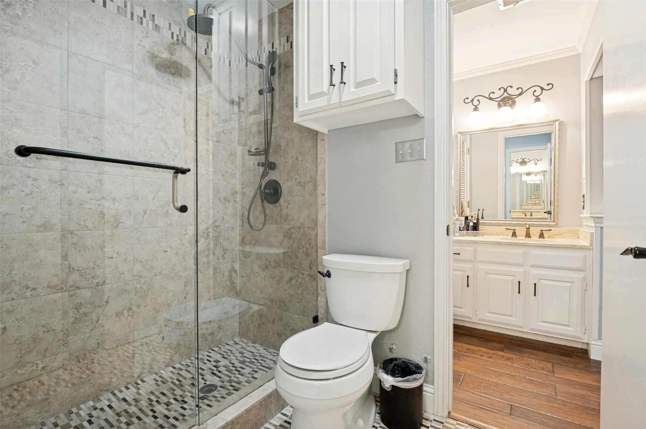 Spacious primary bathroom with separate vanities and sinks.