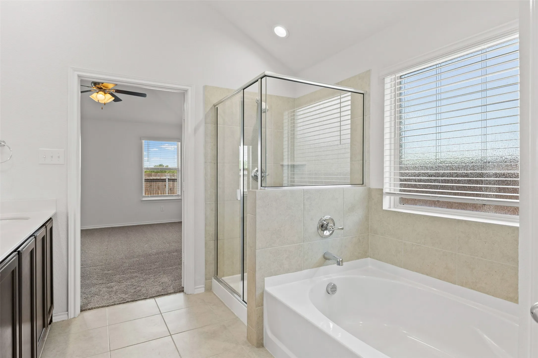 Primary bathroom has double sinks, separate shower and tub, plus a linen closet