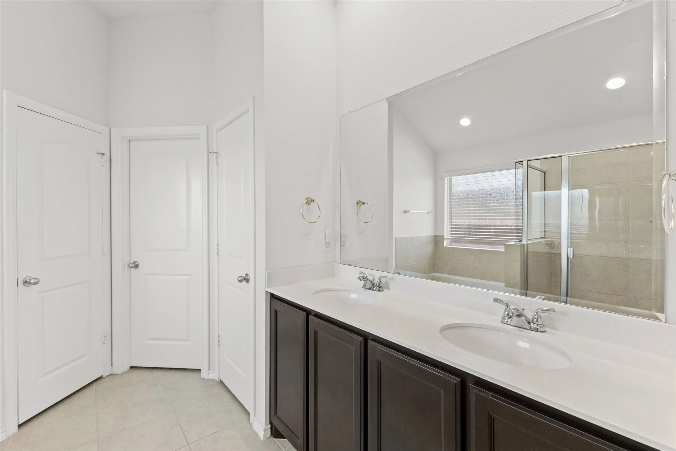 Primary bathroom has double sinks, separate shower and tub, plus a linen closet
