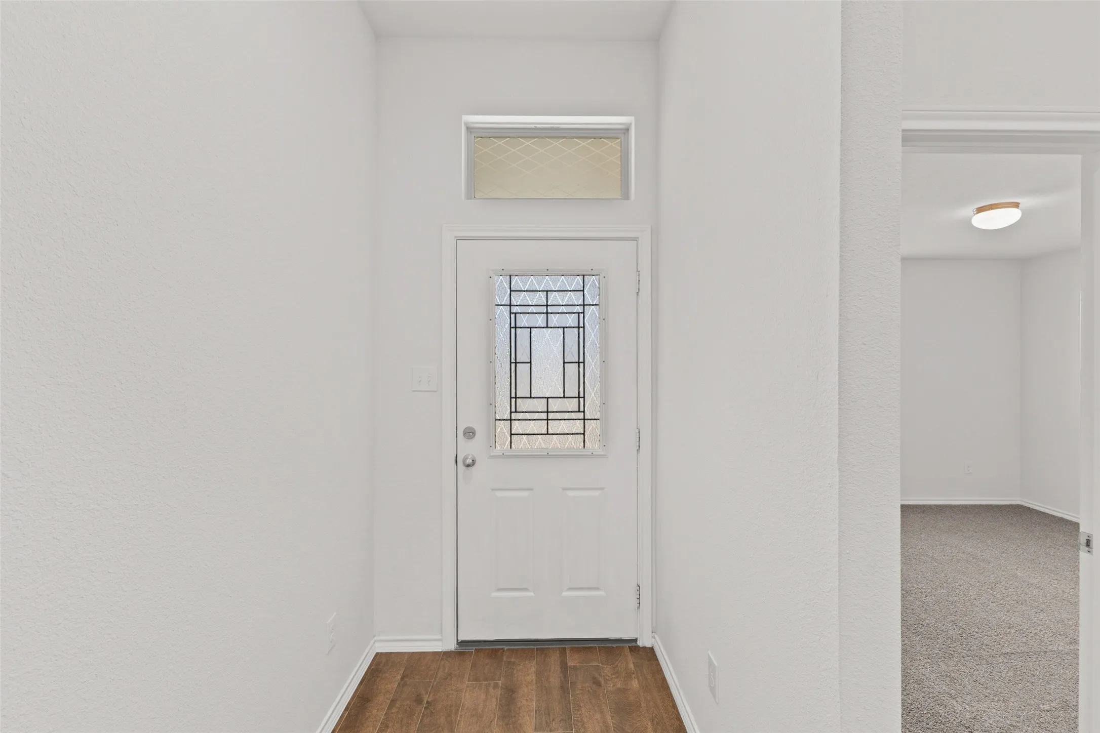 View of the front door and bedroom #2 at the front of the home