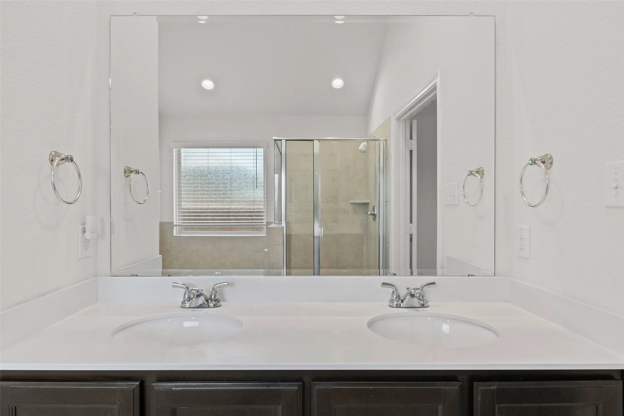 Primary bathroom has double sinks, separate shower and tub, plus a linen closet