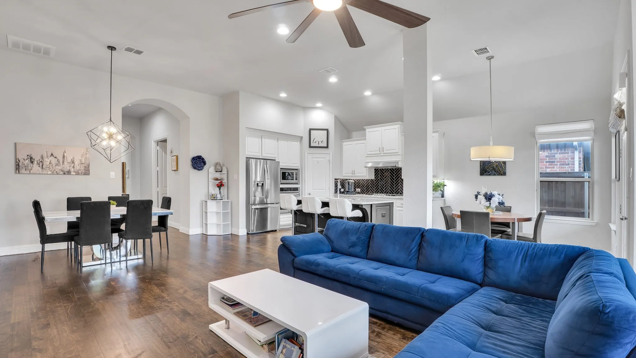 Wood-finish flooring, recessed lighting, and a vaulted ceiling