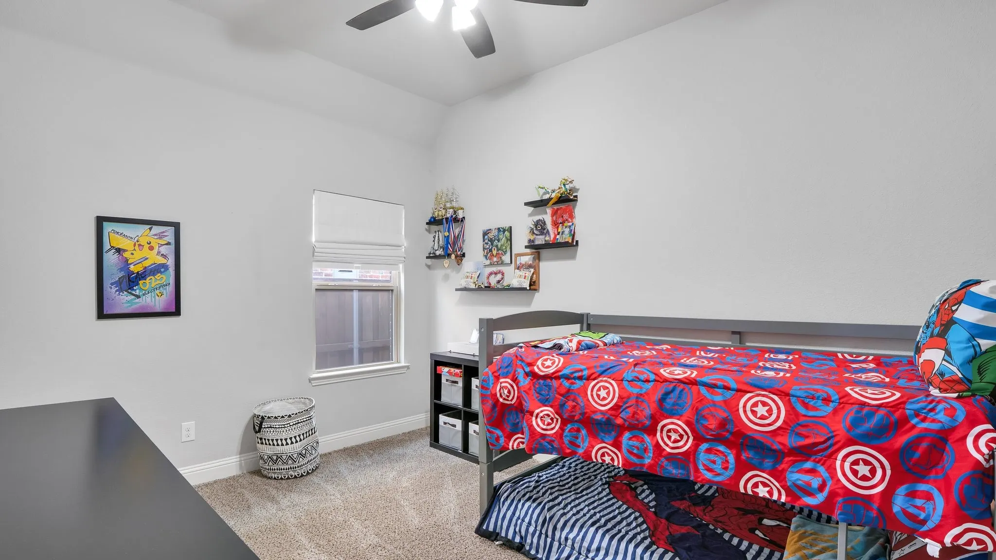 Carpeted flooring, window with blinds, ceiling fan with light fixture, built-in shelving