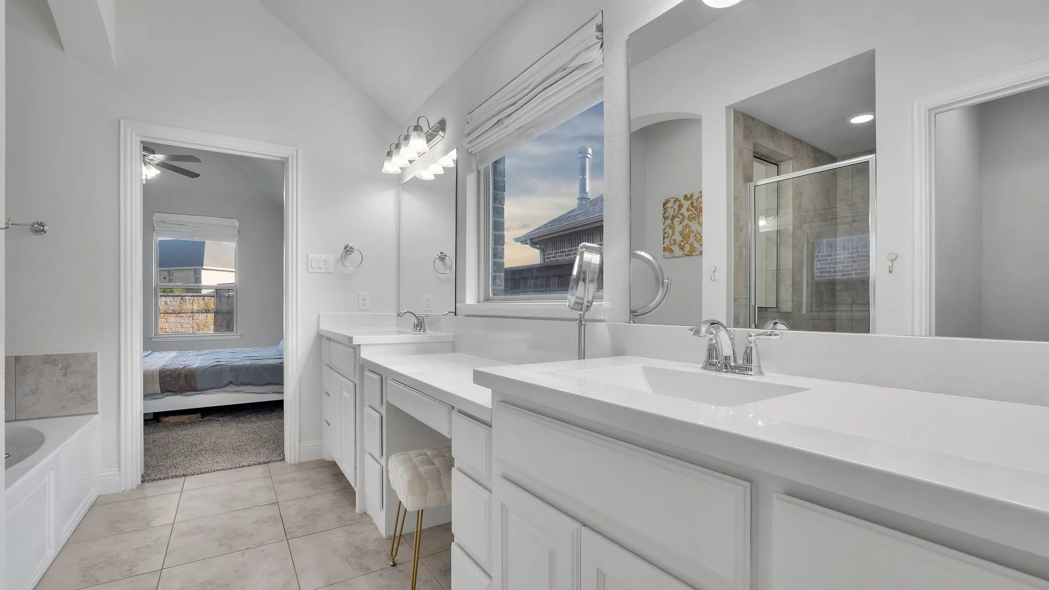 Dual vanity with white cabinetry and integrated sinks