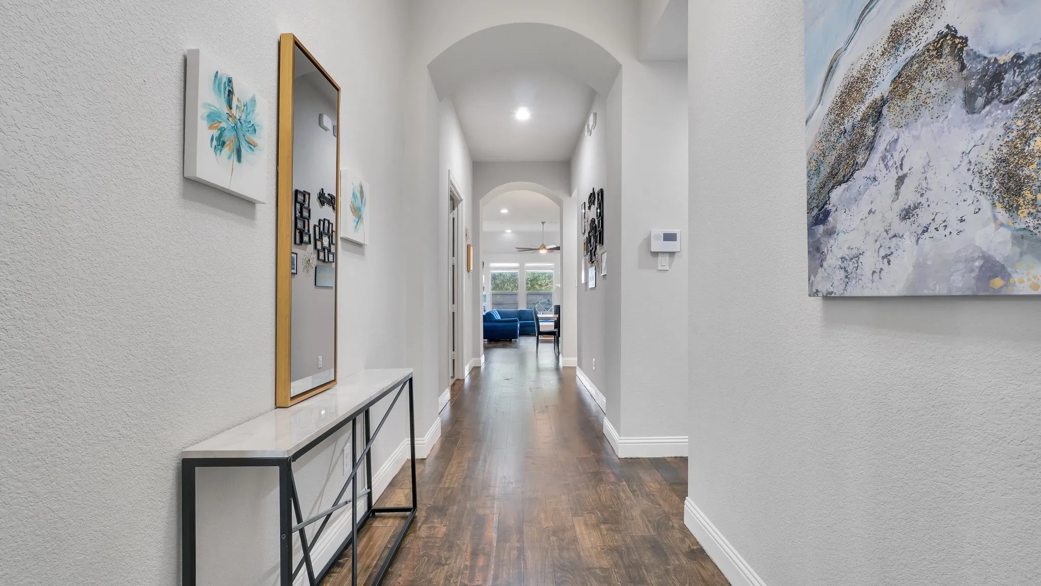 Arched doorways, recessed lighting, and wood-finish flooring