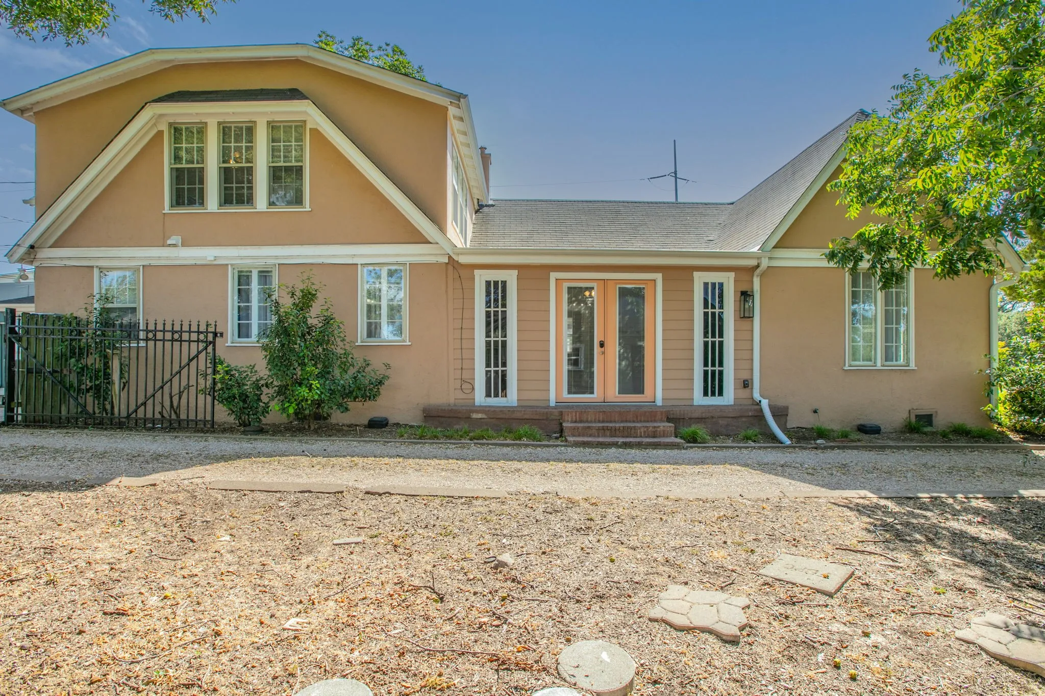 Stucco exterior with multiple white-framed windows