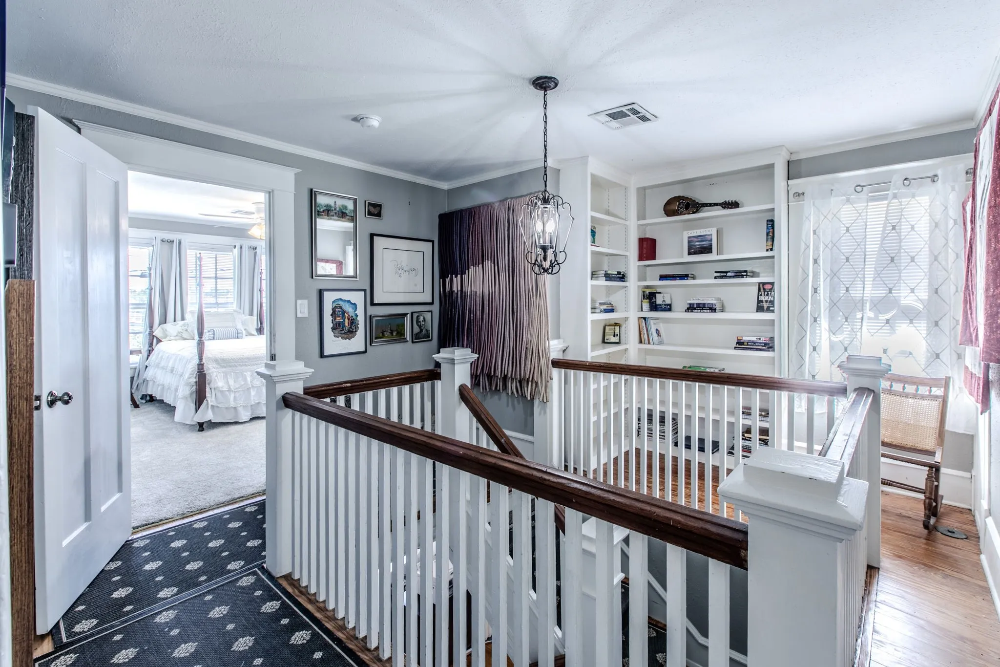 Staircase with wood-finish handrail and white balusters