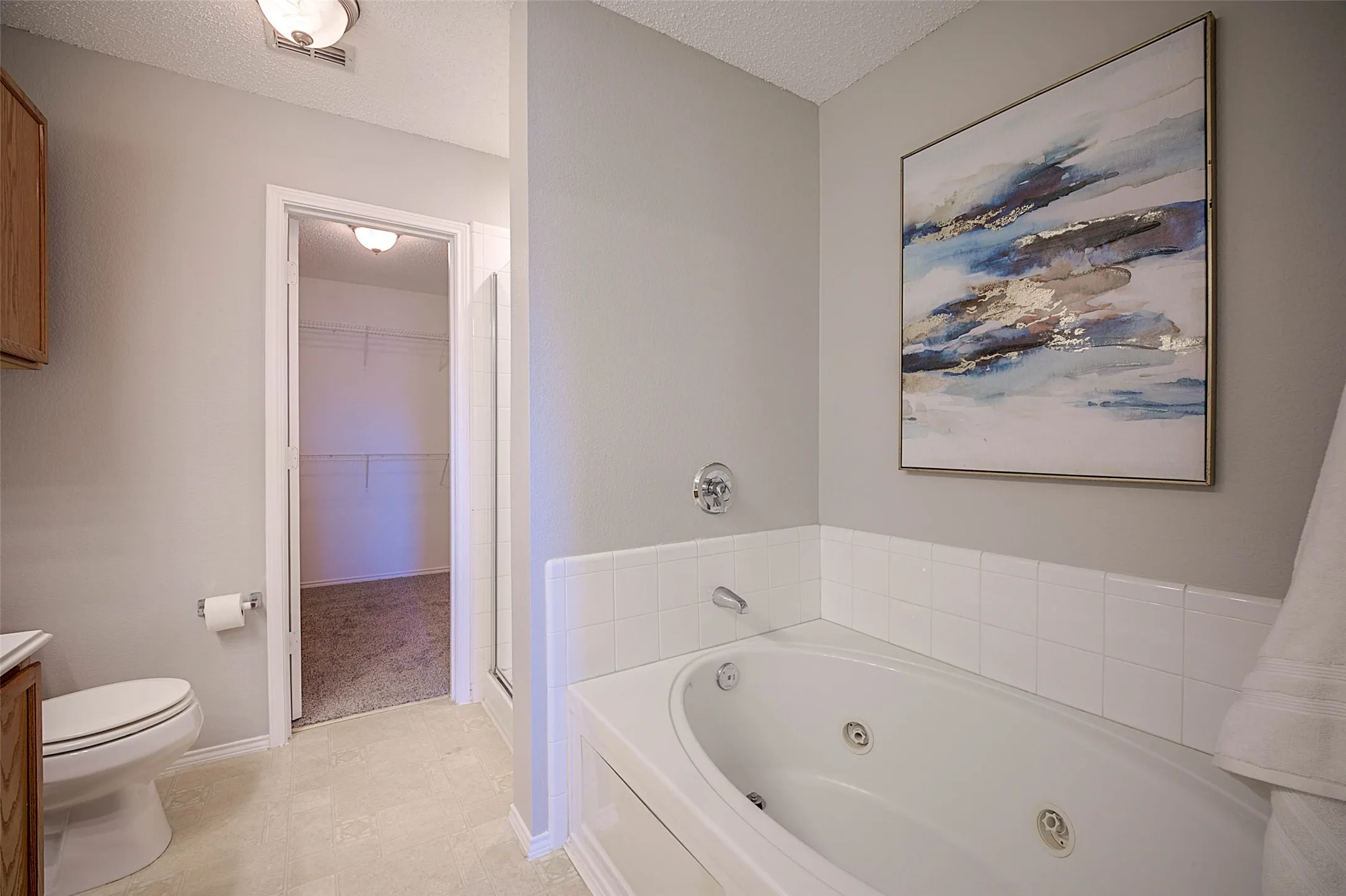 Jetted soaking tub with white tile surround
