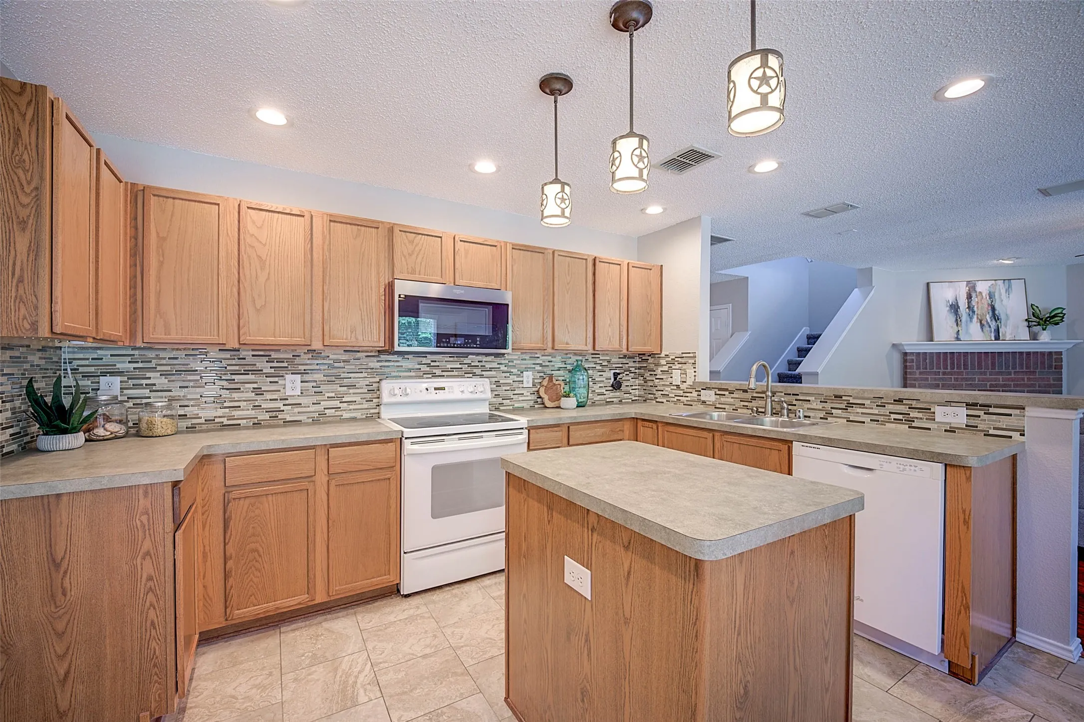 Kitchen featuring wood-finish cabinetry, tile flooring, and a mosaic tile backsplash
