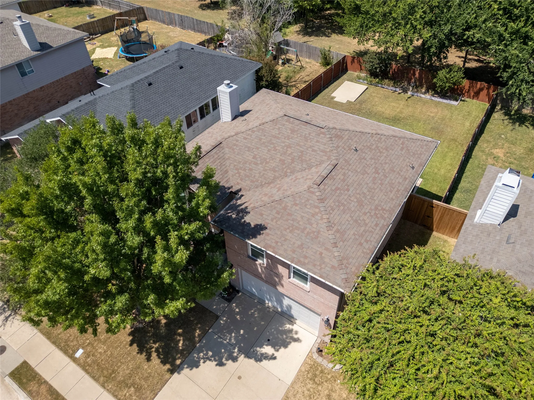 Two-story residence with a brick and siding exterior, an attached garage, and a concrete driveway