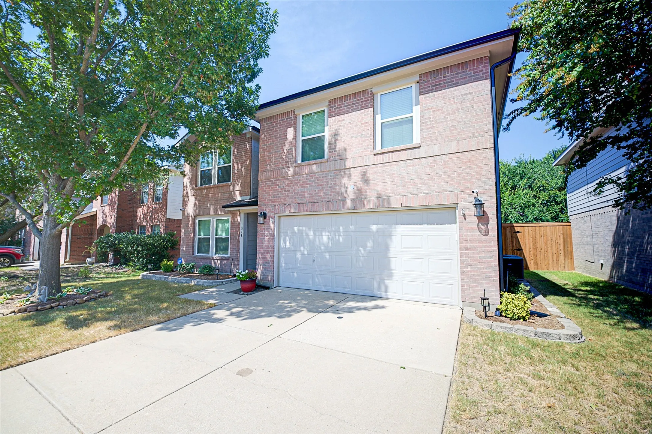 Two-story brick exterior with a front-facing garage