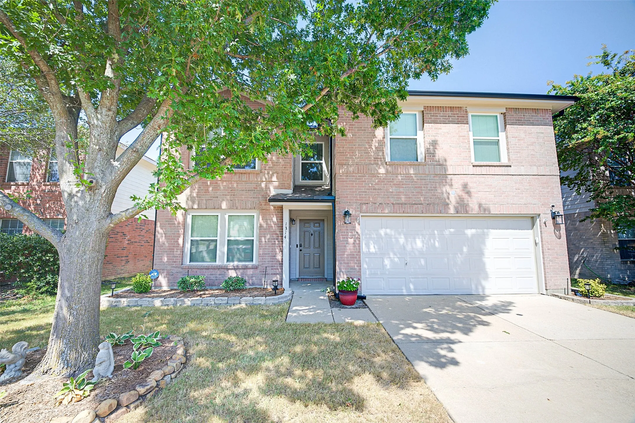 Brick exterior with a prominent two-car garage