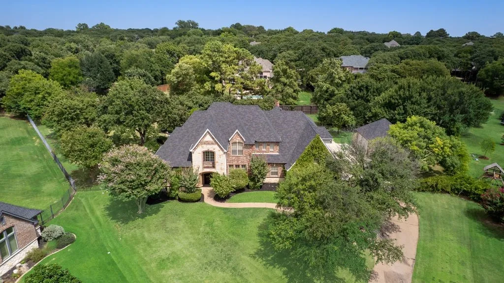 Stone and brick facade. Newer (2021) architectural shingle roof and multiple gables.