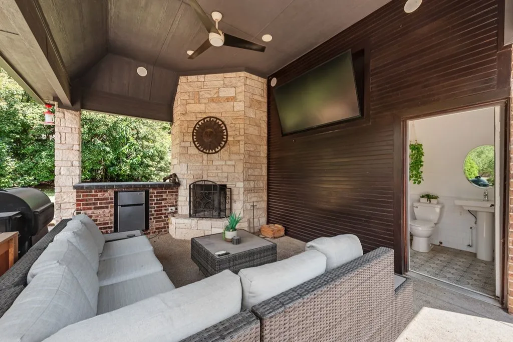 Outdoor living space with TV, fireplace, refrigerator and full bathroom!