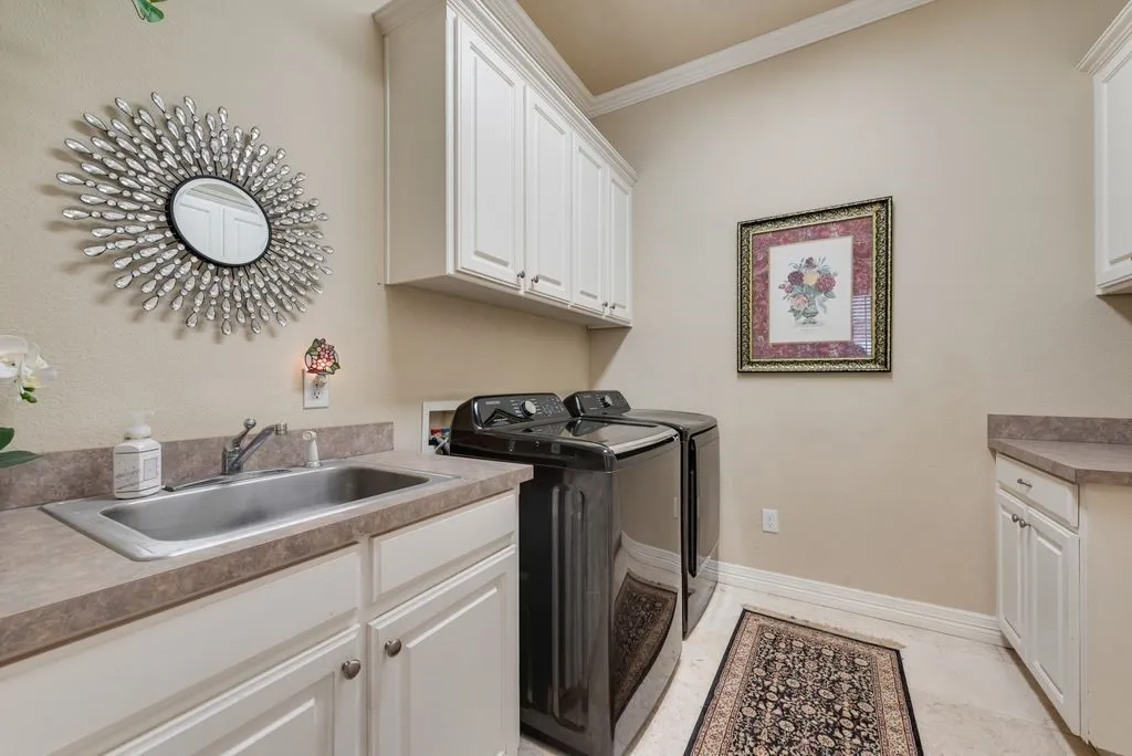Utility room with sink, counter space and built-ins.