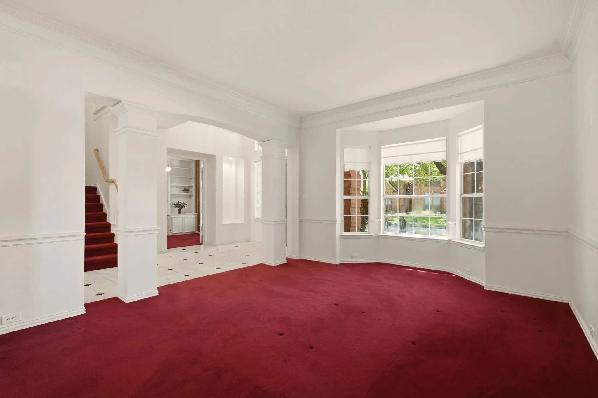 Architectural features include crown molding, art alcoves, chair rail