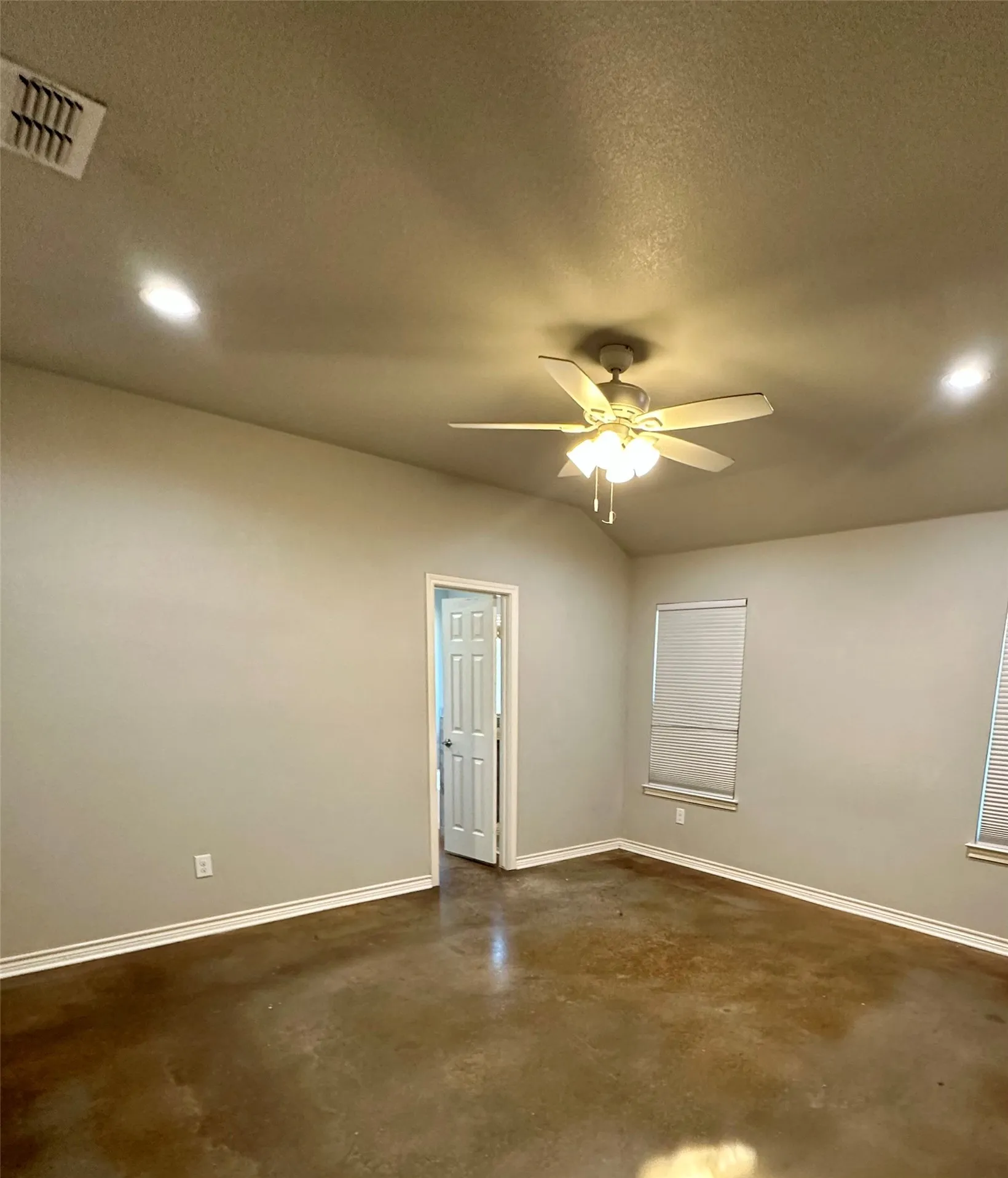 Unfurnished room with concrete floors, recessed lighting, baseboards, ceiling fan, and a textured ceiling