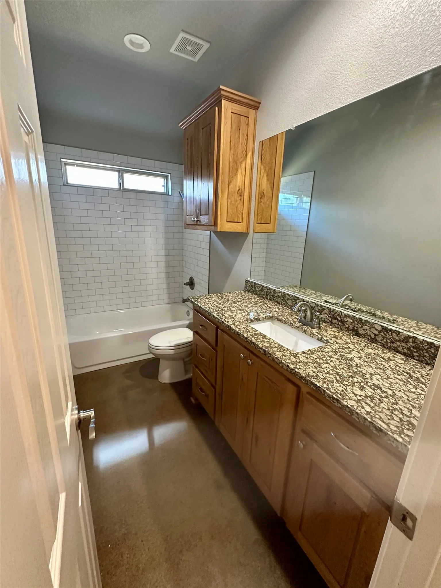 Full bath with toilet, vanity, and washtub / shower combination