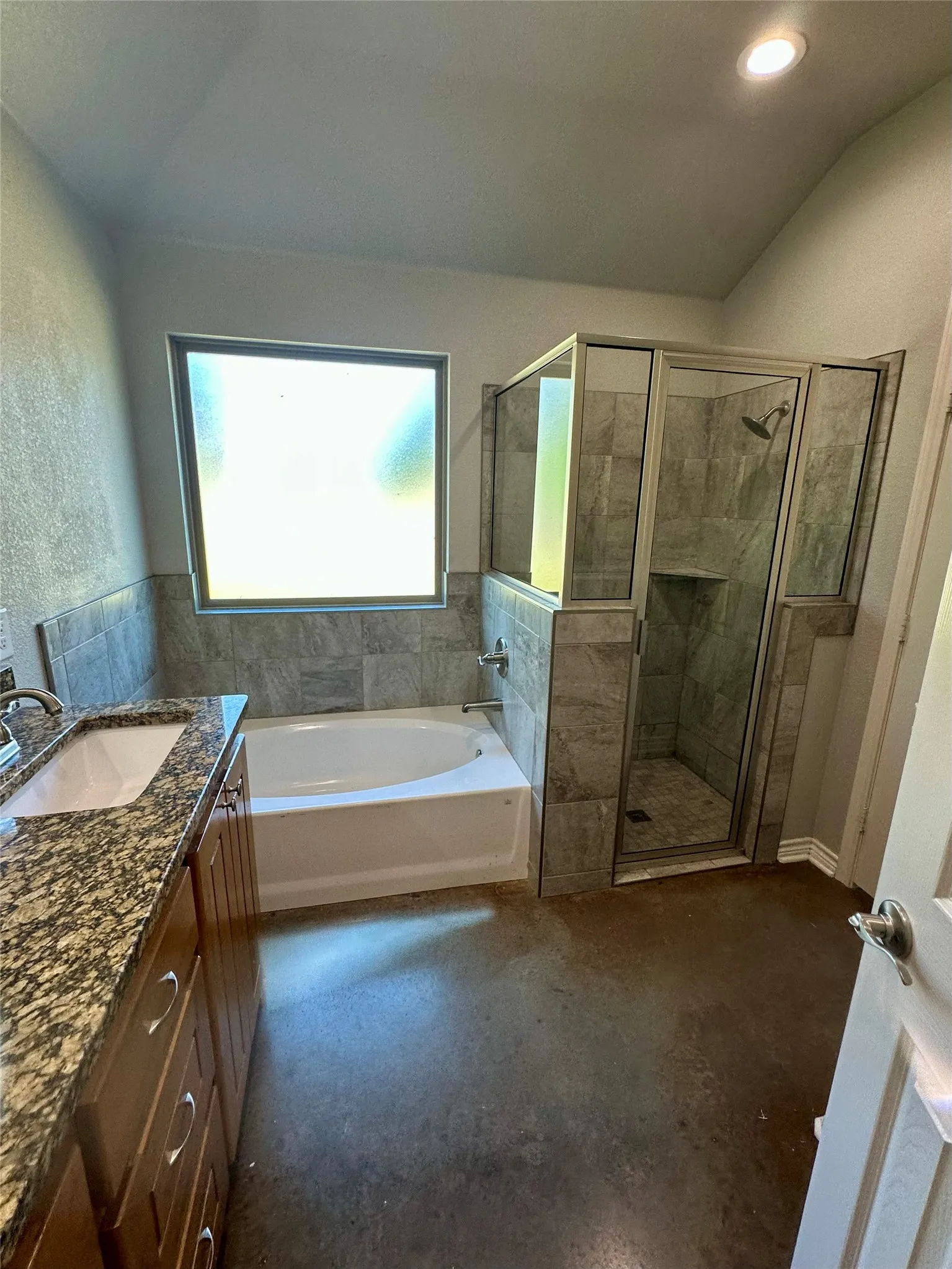 Bathroom featuring a bath, a stall shower, vanity, and recessed lighting
