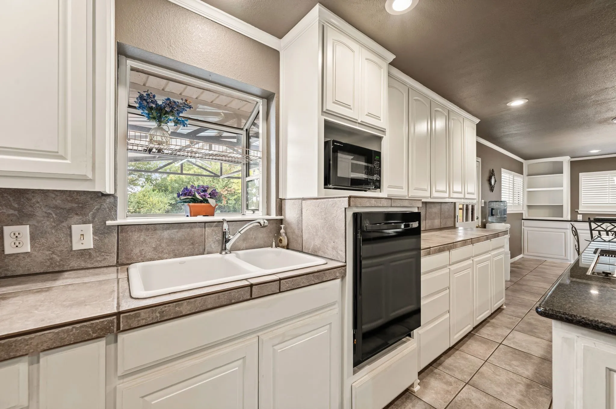 Elevated dishwasher saves from stooping to load.