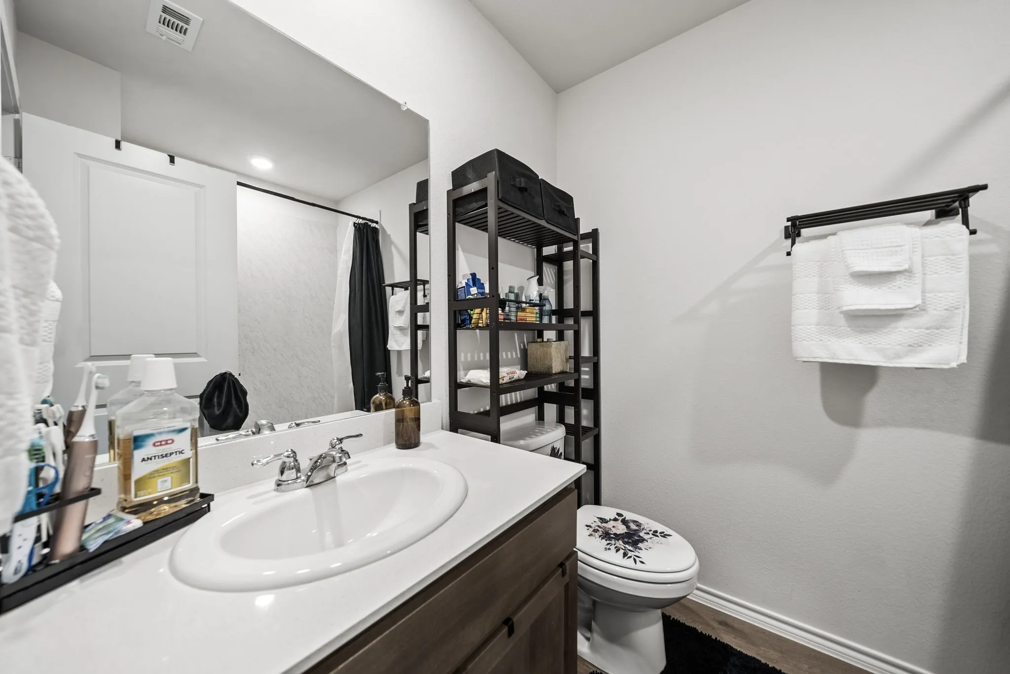 White countertop with an oval under-mount sink and chrome faucet